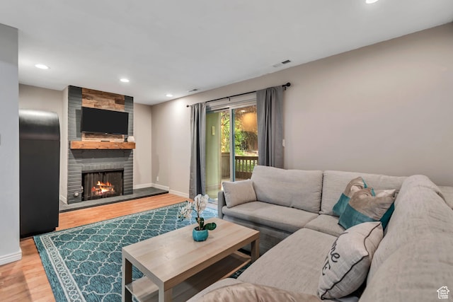 5398 S Tonalea Dr, Salt Lake City, UT 84107 - living area with wood finished floors, a large fireplace, and recessed lighting