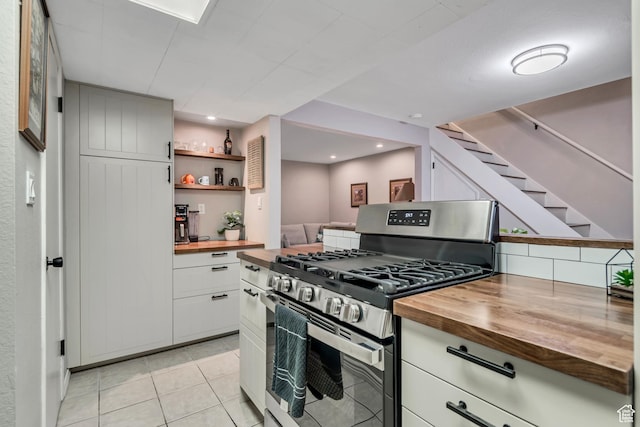 5398 S Tonalea Dr, Salt Lake City, UT 84107 - kitchen featuring stainless steel gas stove, wooden counters, light tile patterned floors, and white cabinets