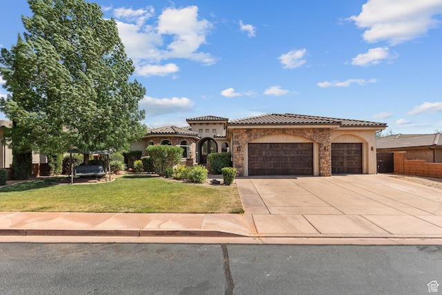 480 W Tonapah Way, Ivins, UT 84738 - mediterranean / spanish house featuring a garage, concrete driveway, stucco siding, a tile roof, and stone siding