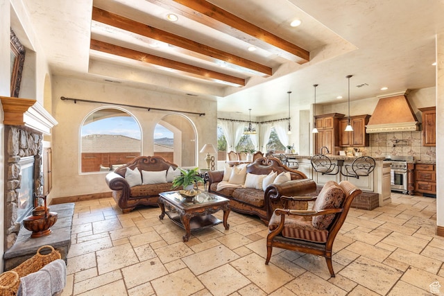 480 W Tonapah Way, Ivins, UT 84738 - living room with stone tile flooring, healthy amount of natural light, beam ceiling, recessed lighting, and a stone fireplace