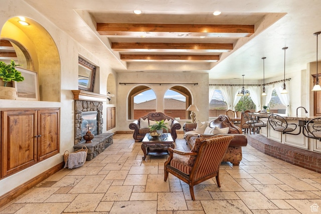 480 W Tonapah Way, Ivins, UT 84738 - living room with stone tile flooring, beamed ceiling, a stone fireplace, and recessed lighting