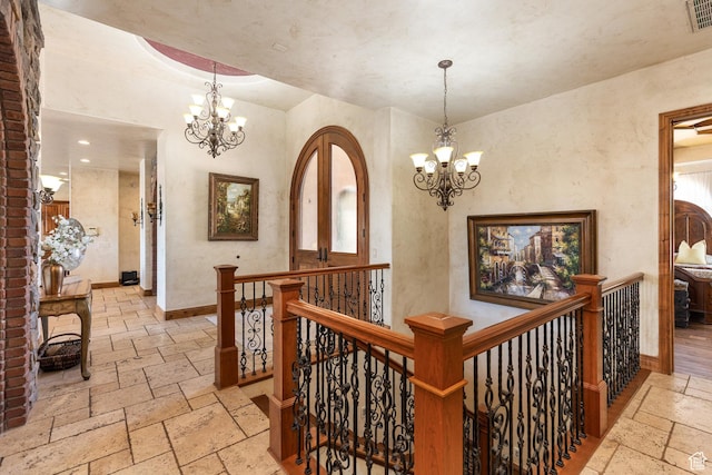 480 W Tonapah Way, Ivins, UT 84738 - hallway with stone tile floors, a chandelier, an upstairs landing, and recessed lighting