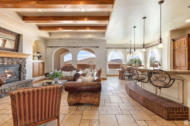 480 W Tonapah Way, Ivins, UT 84738 - living room featuring stone tile floors, a fireplace, beamed ceiling, and recessed lighting