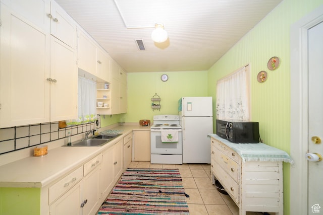 742 N 300 E, Logan, UT 84321 - kitchen with white appliances, light countertops, light tile patterned floors, and white cabinets
