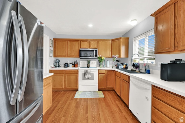 2221 W Davenshire Ln, Taylorsville, UT 84129 - kitchen featuring stainless steel appliances, light wood-type flooring, light countertops, recessed lighting, and brown cabinetry
