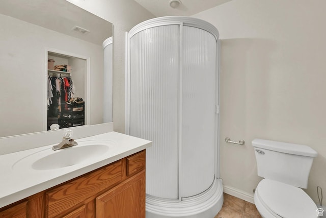 2221 W Davenshire Ln, Taylorsville, UT 84129 - full bathroom with a shower stall, vanity, a spacious closet, and tile patterned floors