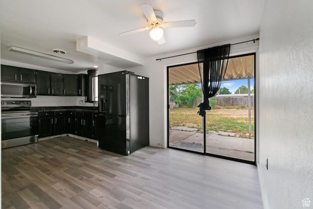 3310 S 3200 W, West Valley City, UT 84119 - kitchen featuring appliances with stainless steel finishes, dark cabinets, dark countertops, wood finished floors, and a ceiling fan