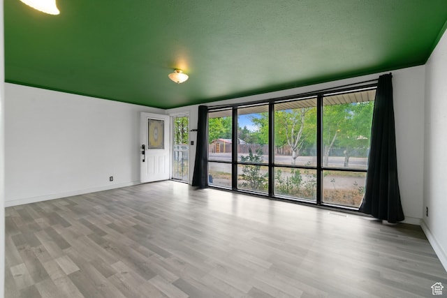 3310 S 3200 W, West Valley City, UT 84119 - unfurnished room with wood finished floors and a wall of windows