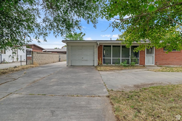 3310 S 3200 W, West Valley City, UT 84119 - view of front of house with concrete driveway, brick siding, and a garage