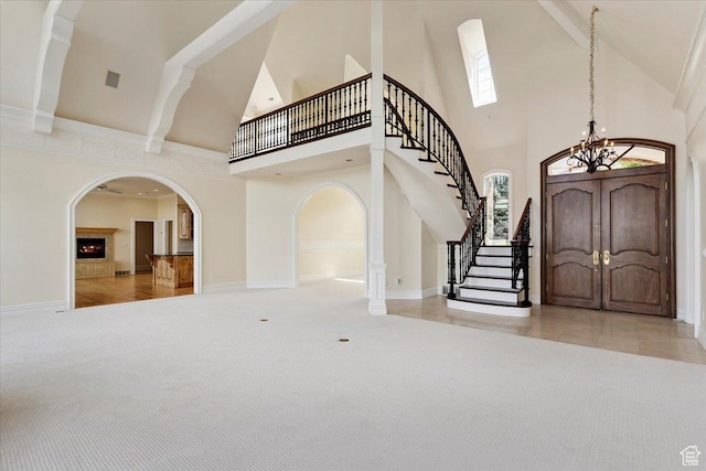3356 Twin Peaks Cir, Layton, UT 84040 - carpeted foyer with high vaulted ceiling, stairs, a chandelier, and arched walkways