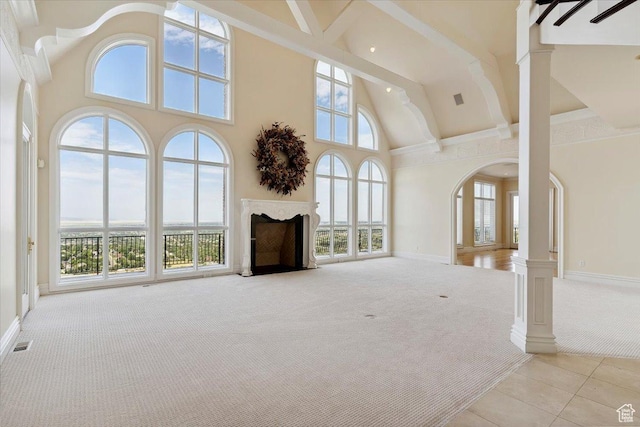 3356 Twin Peaks Cir, Layton, UT 84040 - unfurnished living room featuring light colored carpet, high vaulted ceiling, a fireplace, light tile patterned flooring, and ornate columns