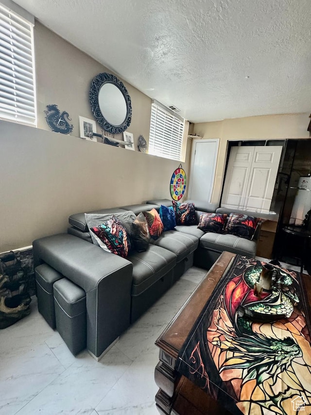1360 W 7305 S, West Jordan, UT 84084 - living room featuring a textured ceiling and marble look tile flooring