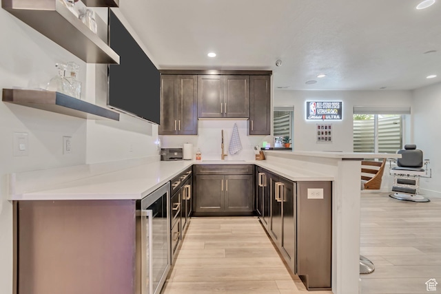 11536 S Allerton Dr, South Jordan, UT 84009 - kitchen featuring open shelves, a peninsula, wine cooler, light wood-type flooring, and light countertops