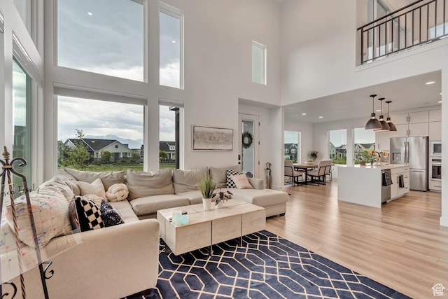 11536 S Allerton Dr, South Jordan, UT 84009 - living room featuring light wood-type flooring and a towering ceiling