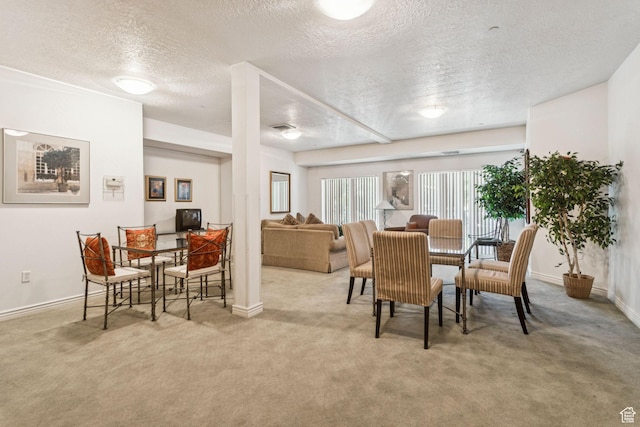 838 E S Temple S Unit 409, Salt Lake City, UT 84102 - dining space featuring a textured ceiling and carpet
