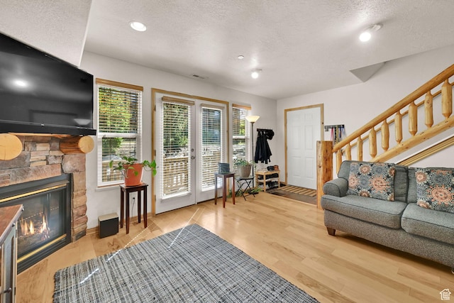 5060 E Lakeview Dr Unit 1109, Eden, UT 84310 - living room featuring a textured ceiling, stairway, recessed lighting, wood finished floors, and a stone fireplace