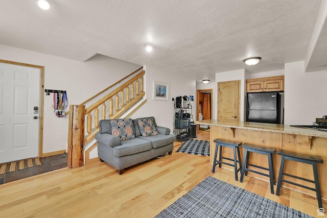 5060 E Lakeview Dr Unit 1109, Eden, UT 84310 - living room with light wood-style flooring, stairway, and a textured ceiling