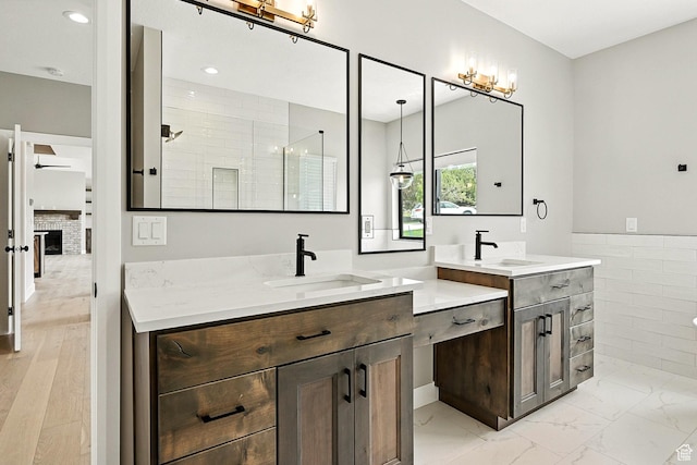 3127 W 2350 S, Cedar City, UT 84720 - bathroom featuring two vanities, tiled shower, marble finish flooring, tile walls, and recessed lighting