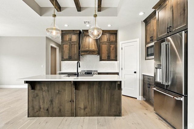 3127 W 2350 S, Cedar City, UT 84720 - kitchen featuring stainless steel appliances, custom exhaust hood, light countertops, decorative backsplash, and light wood-style floors