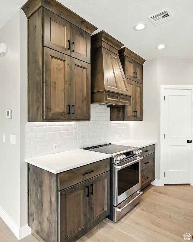 3127 W 2350 S, Cedar City, UT 84720 - kitchen featuring electric range, custom range hood, light wood-style floors, decorative backsplash, and recessed lighting