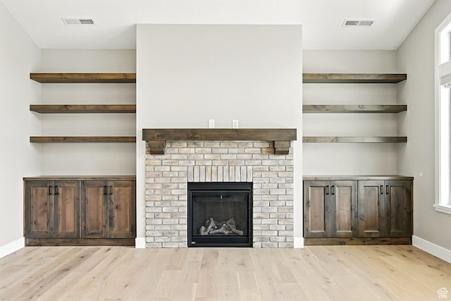 3127 W 2350 S, Cedar City, UT 84720 - unfurnished living room featuring wood finished floors, healthy amount of natural light, and a brick fireplace