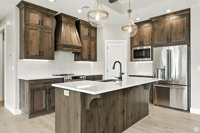 3127 W 2350 S, Cedar City, UT 84720 - kitchen featuring appliances with stainless steel finishes, custom range hood, light wood finished floors, light countertops, and recessed lighting