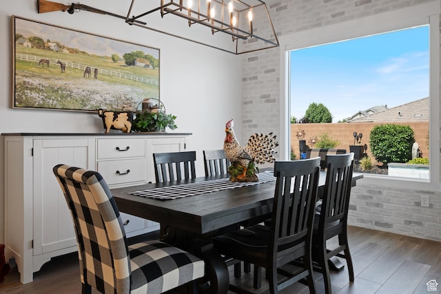2616 S 3210 E, St George, UT 84790 - dining area featuring wood finished floors, brick wall, and a chandelier