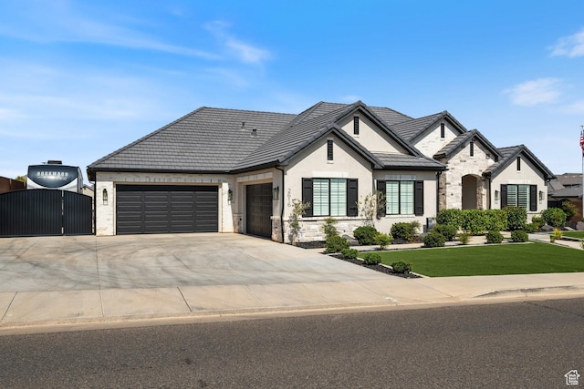 2616 S 3210 E, St George, UT 84790 - french provincial home featuring stone siding, a garage, a gate, concrete driveway, and stucco siding