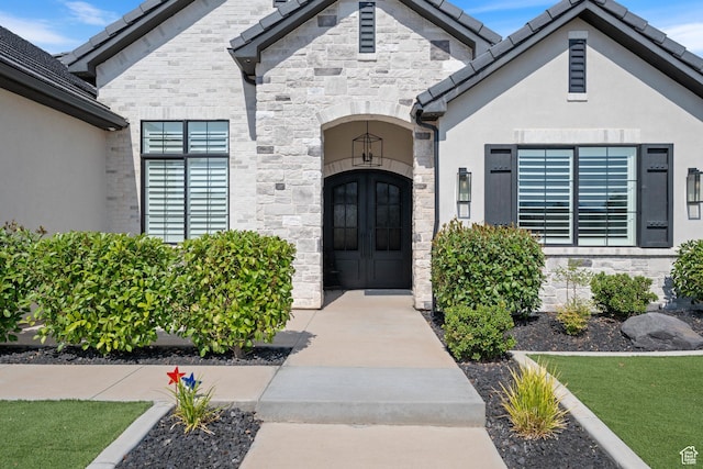 2616 S 3210 E, St George, UT 84790 - doorway to property featuring stone siding, stucco siding, and french doors