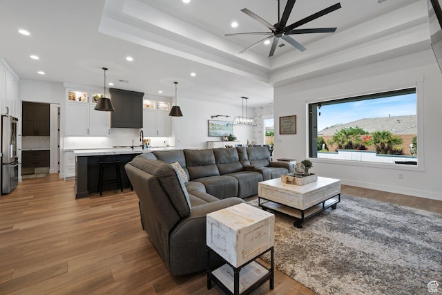 2616 S 3210 E, St George, UT 84790 - living room featuring a ceiling fan, recessed lighting, a tray ceiling, wood finished floors, and a chandelier