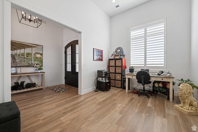 2616 S 3210 E, St George, UT 84790 - home office featuring light wood finished floors, a chandelier, a towering ceiling, and arched walkways