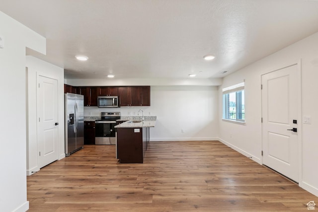 456 W Main N, Santaquin, UT 84655 - kitchen with appliances with stainless steel finishes, dark brown cabinetry, light wood finished floors, recessed lighting, and open floor plan
