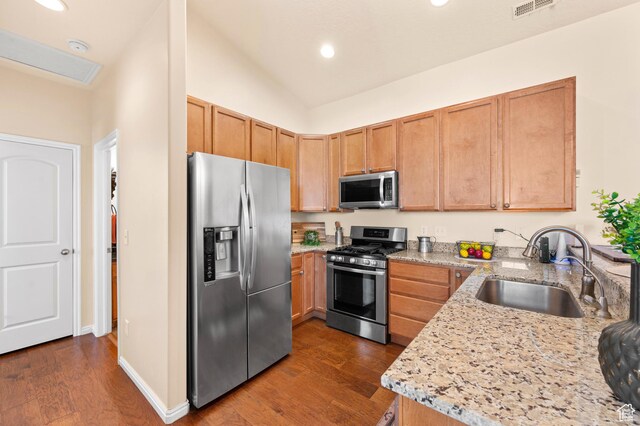 6391 W Passenger Ct S, West Jordan, UT 84081 - kitchen featuring appliances with stainless steel finishes, dark wood-style floors, recessed lighting, light stone counters, and vaulted ceiling