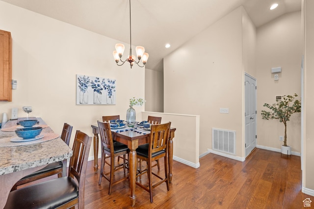 6391 W Passenger Ct S, West Jordan, UT 84081 - dining area with wood finished floors, a chandelier, vaulted ceiling, and recessed lighting