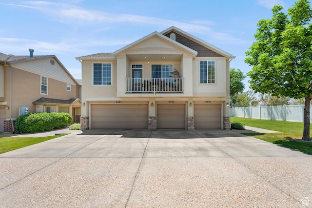 6391 W Passenger Ct S, West Jordan, UT 84081 - view of front facade with stone siding, a balcony, concrete driveway, an attached garage, and stucco siding
