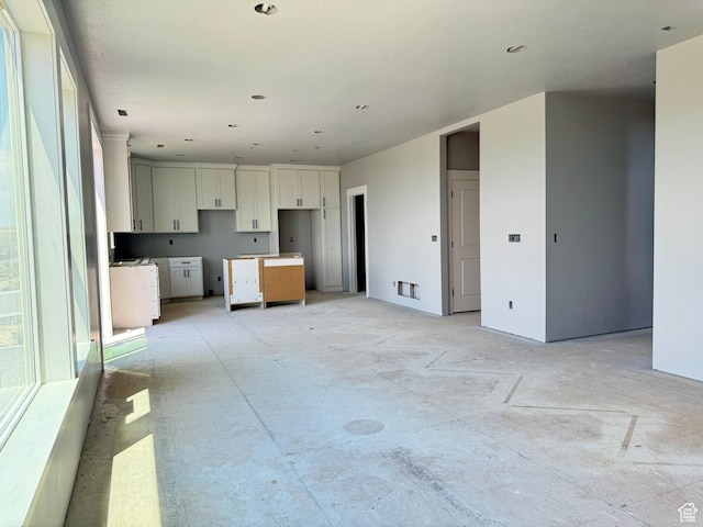 565 S 1140 E Unit 1203, Smithfield, UT 84335 - kitchen with unfinished concrete floors and white cabinets