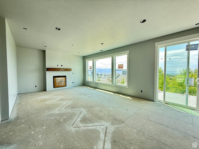 565 S 1140 E Unit 1203, Smithfield, UT 84335 - unfurnished living room with a textured ceiling and a fireplace