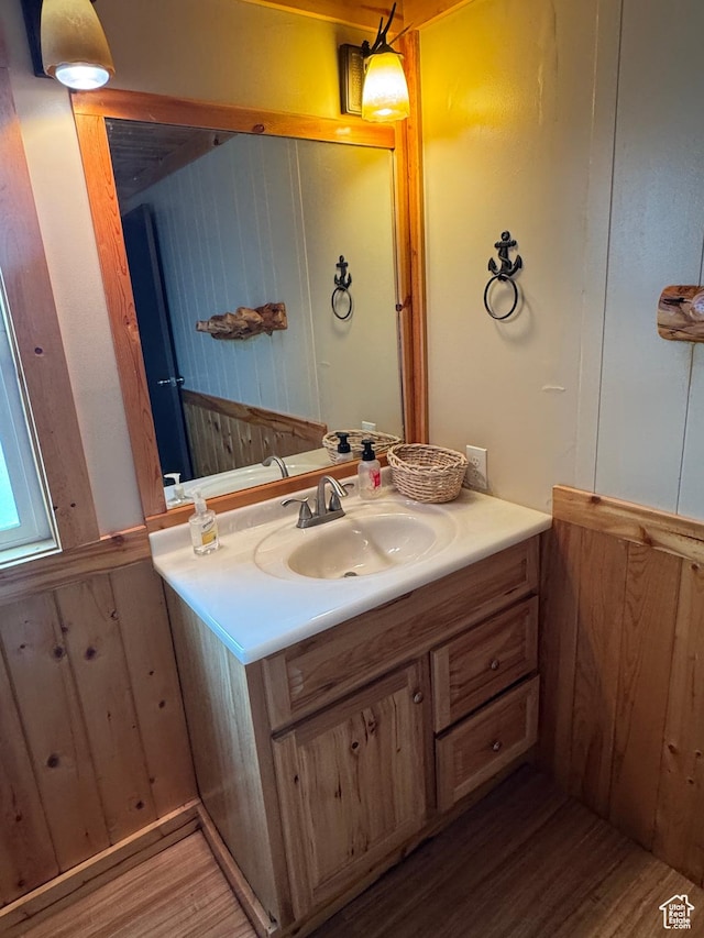 738 E Vanessa Ln Unit 386, Garden City, UT 84028 - bathroom featuring vanity, wood finished floors, and wood walls