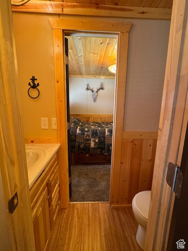 738 E Vanessa Ln Unit 386, Garden City, UT 84028 - bathroom with vanity, wooden walls, wood finished floors, and wood ceiling