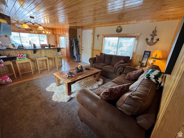 738 E Vanessa Ln Unit 386, Garden City, UT 84028 - living room featuring wooden ceiling, wood walls, wood finished floors, and a chandelier