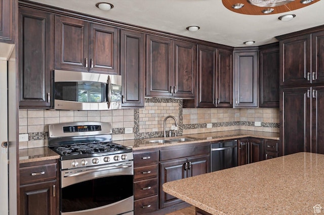 6871 S Alfalfa Cir, West Jordan, UT 84084 - kitchen featuring stainless steel appliances, dark brown cabinetry, decorative backsplash, and light stone counters