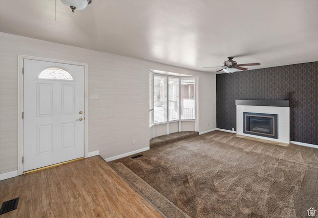 6871 S Alfalfa Cir, West Jordan, UT 84084 - foyer featuring healthy amount of natural light, ceiling fan, a glass covered fireplace, and wallpapered walls