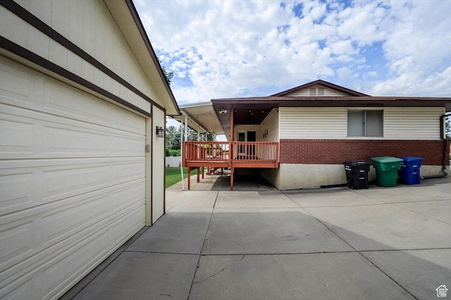 6871 S Alfalfa Cir, West Jordan, UT 84084 - view of property exterior featuring a garage, brick siding, and a wooden deck