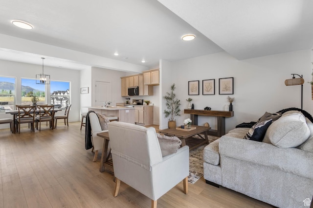 588 W Caroles Way Unit 13, Tooele, UT 84074 - living room featuring light wood-style flooring, recessed lighting, and a chandelier