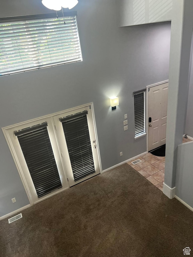 888 N Shepard Creek Pkwy W, Farmington, UT 84025 - carpeted empty room with a high ceiling and tile patterned flooring