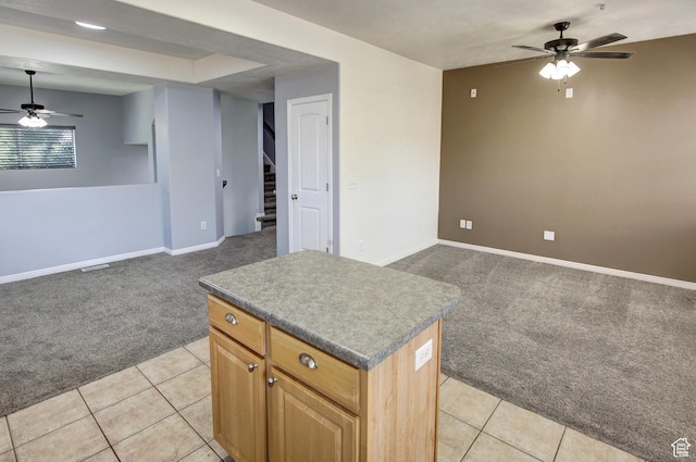 888 N Shepard Creek Pkwy W, Farmington, UT 84025 - kitchen featuring light carpet, ceiling fan, open floor plan, a center island, and light tile patterned floors