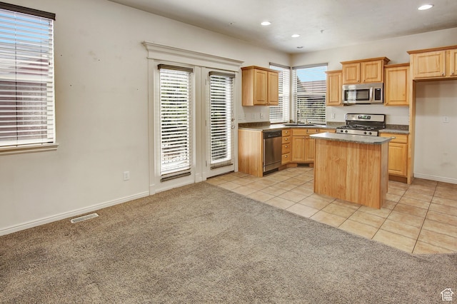 888 N Shepard Creek Pkwy W, Farmington, UT 84025 - kitchen with stainless steel appliances, light tile patterned floors, recessed lighting, a center island, and light carpet