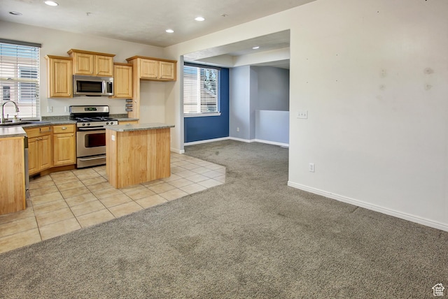 888 N Shepard Creek Pkwy W, Farmington, UT 84025 - kitchen featuring appliances with stainless steel finishes, light carpet, recessed lighting, a kitchen island, and light brown cabinetry