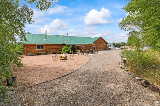 986 E 2290 N, Monroe, UT 84754 - rear view of house with a fire pit, a patio area, and a metal roof