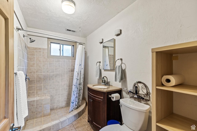 986 E 2290 N, Monroe, UT 84754 - bathroom with a textured ceiling, vanity, a tile shower, and tile patterned flooring